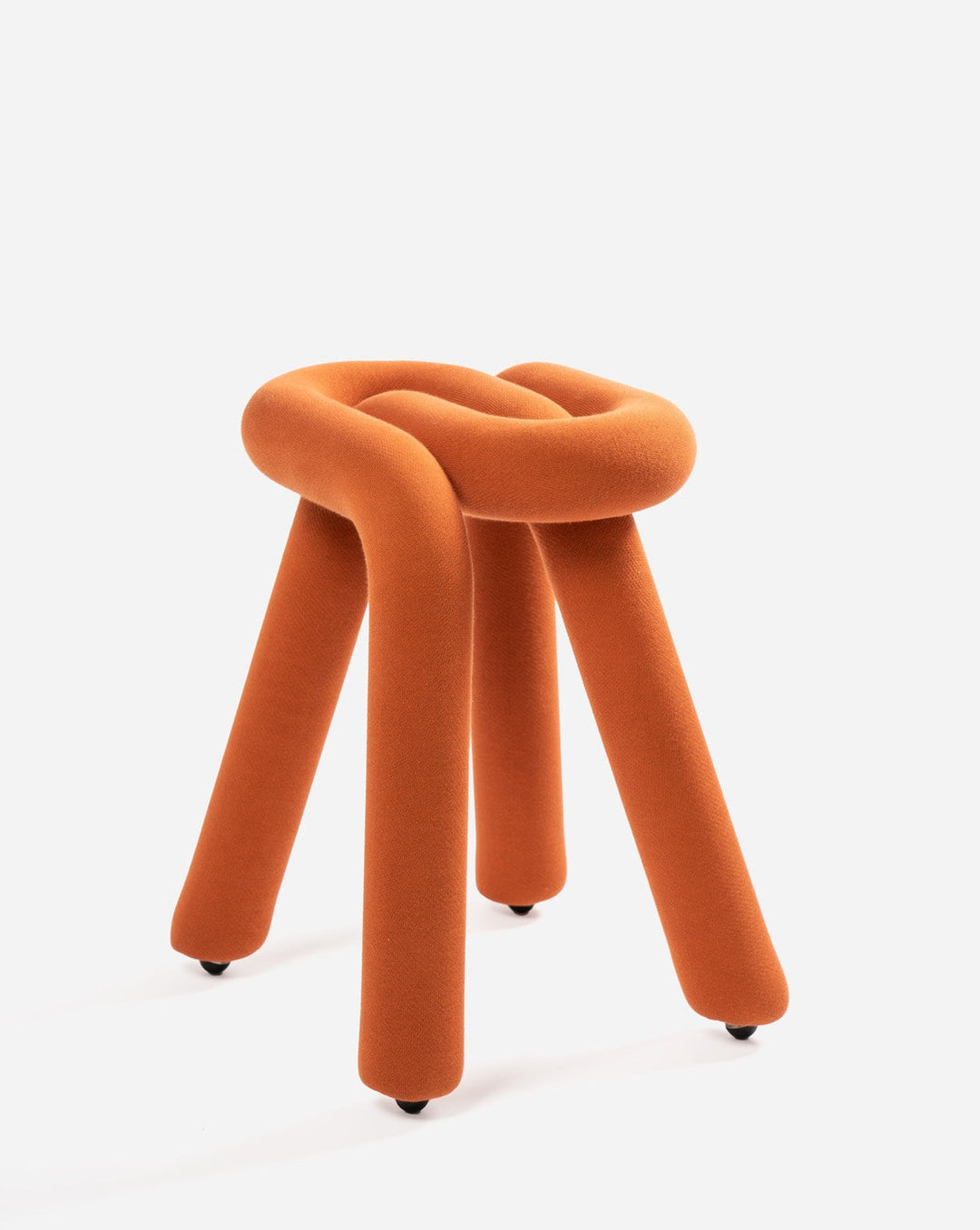 Orange knotted stool by Moustache, with three cylindrical legs and small black wheels.
