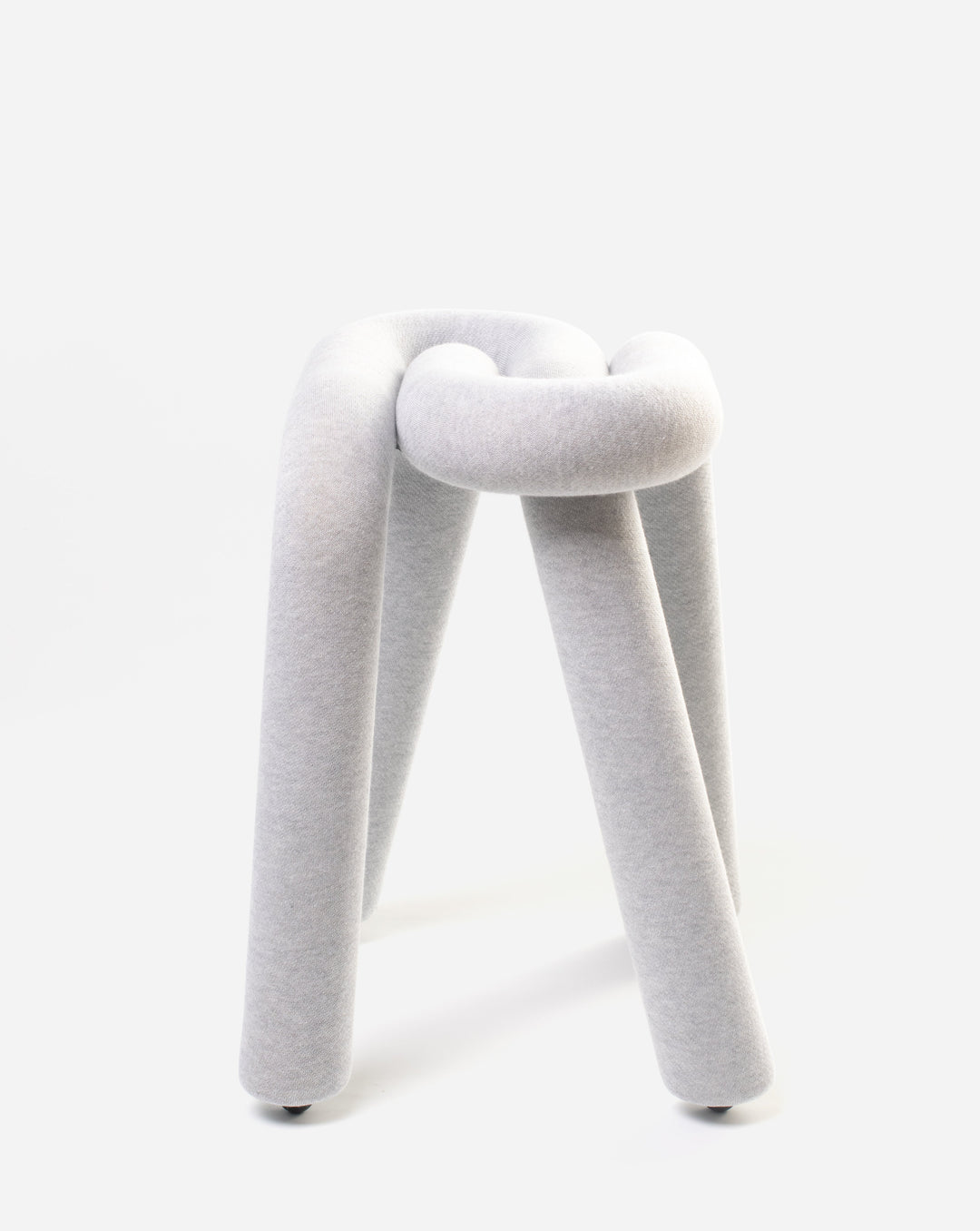 Knot-shaped gray stool by Moustache, made from soft fabric with rounded legs.