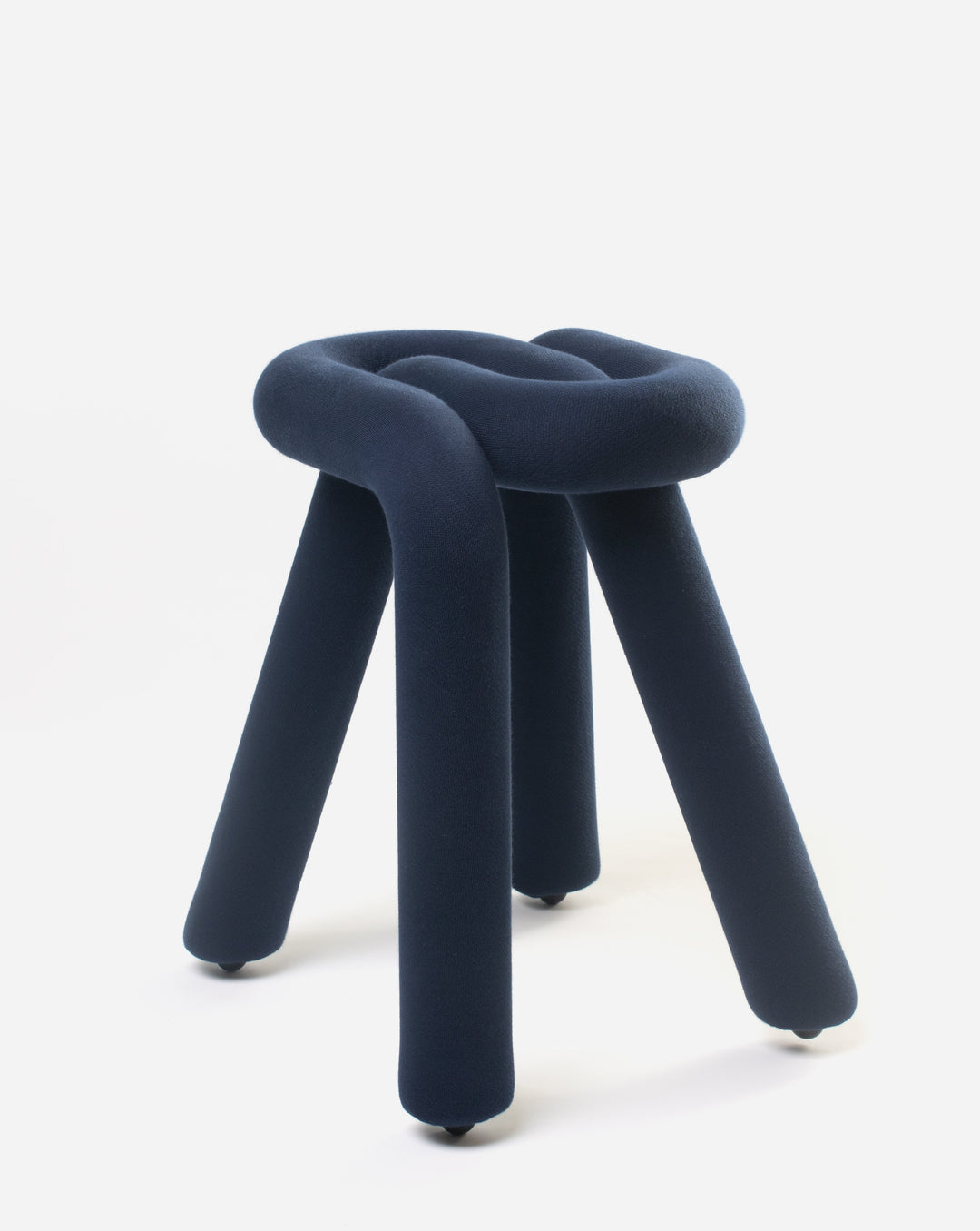 Purple stool by Moustache, featuring a soft, knotted design with four cylindrical legs and small rolling casters.