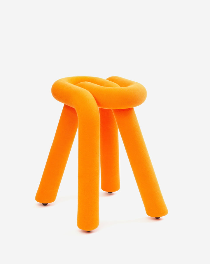 Orange stool by Moustache with a looped top and cylindrical legs, seen against a white background.