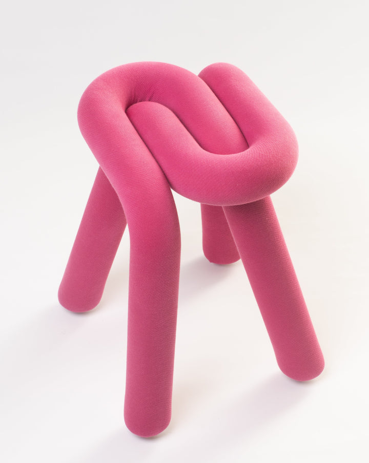Purple stool by Moustache, with a knotted design and cylindrical legs, against a white background.