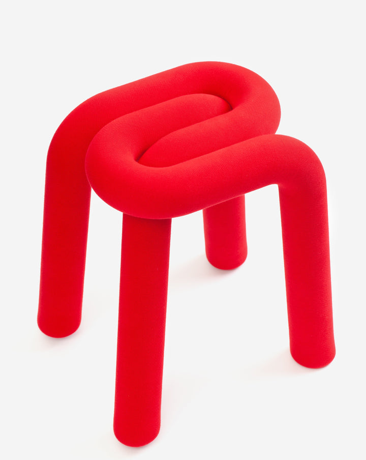 Red upholstered stool with tubular design by Moustache, featuring a soft, textured fabric.