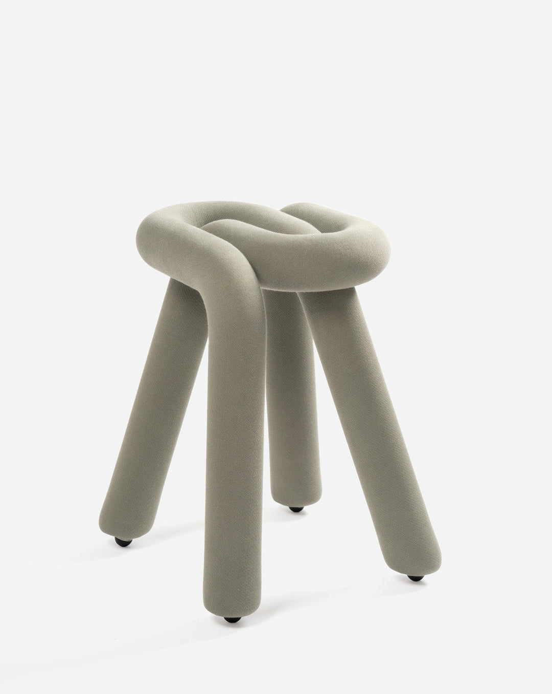 Upholstered gray stool by Moustache with a knotted top and three legs, featuring small black feet.

