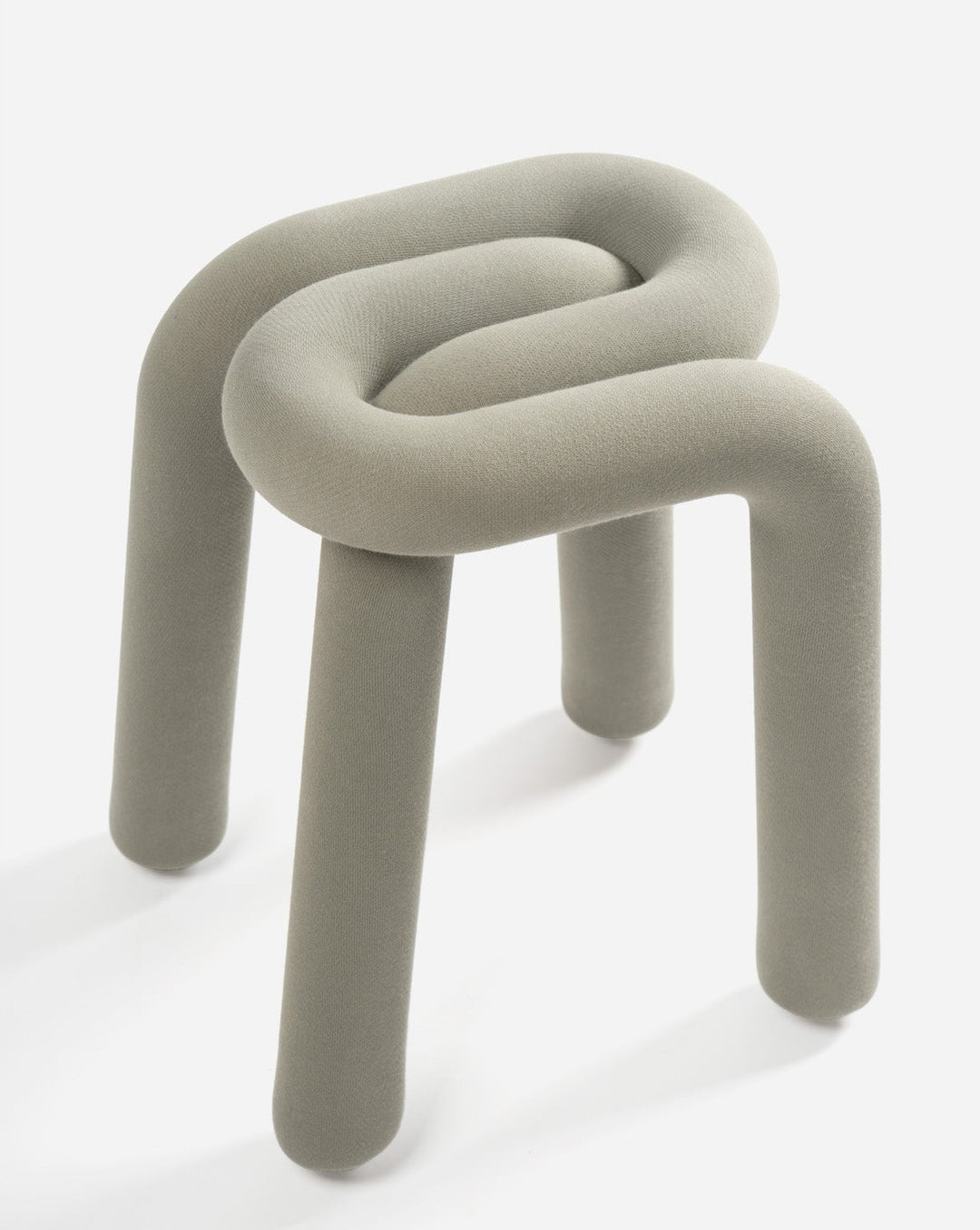 Upholstered grey stool by Moustache with a unique, looped design and three rounded legs.