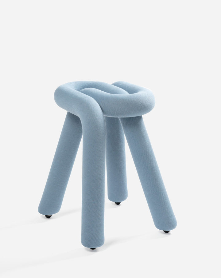 Blue upholstered stool by Moustache with a knotted seat and cylindrical legs.