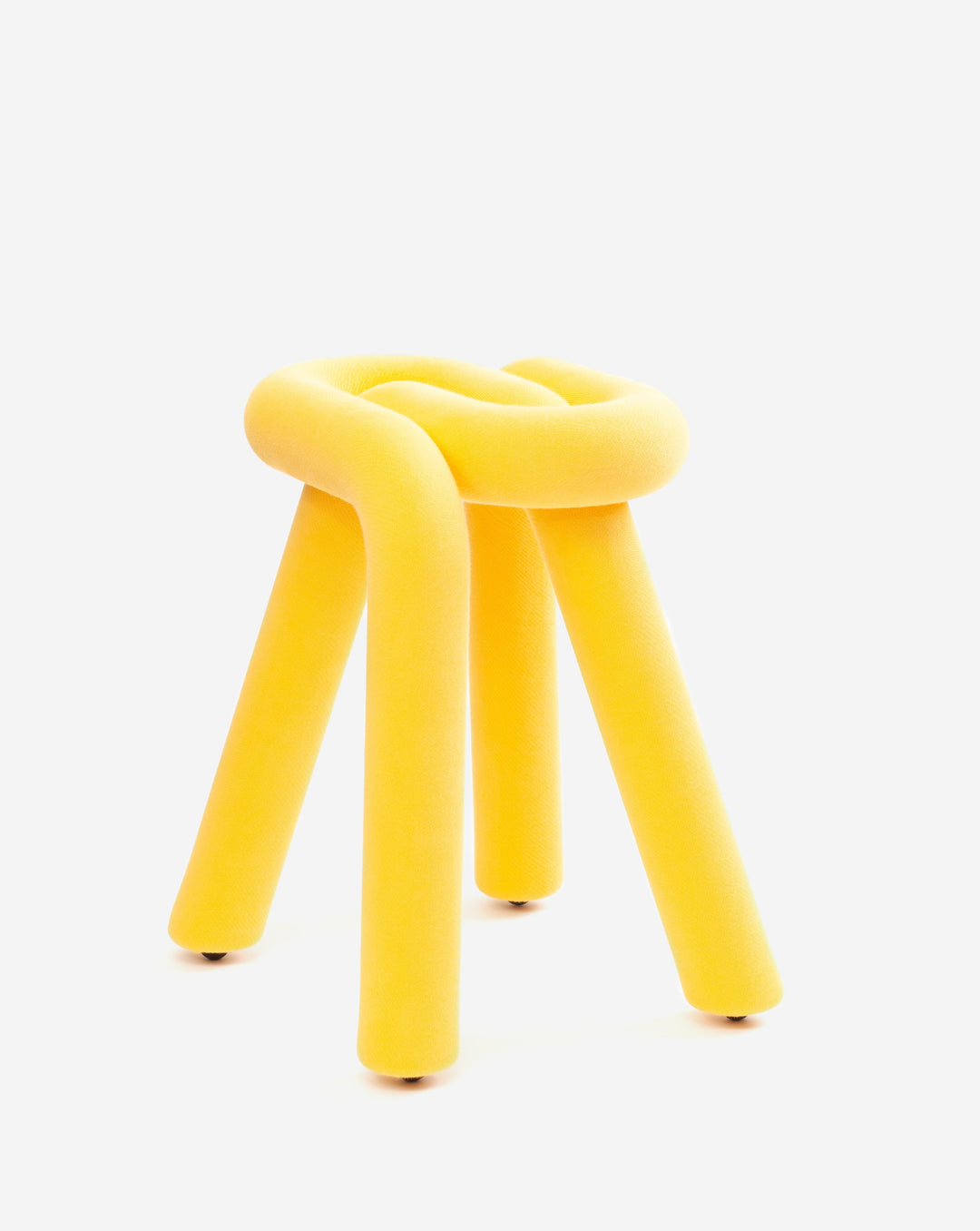Yellow knotted stool by Moustache with three cylindrical legs and textured fabric.