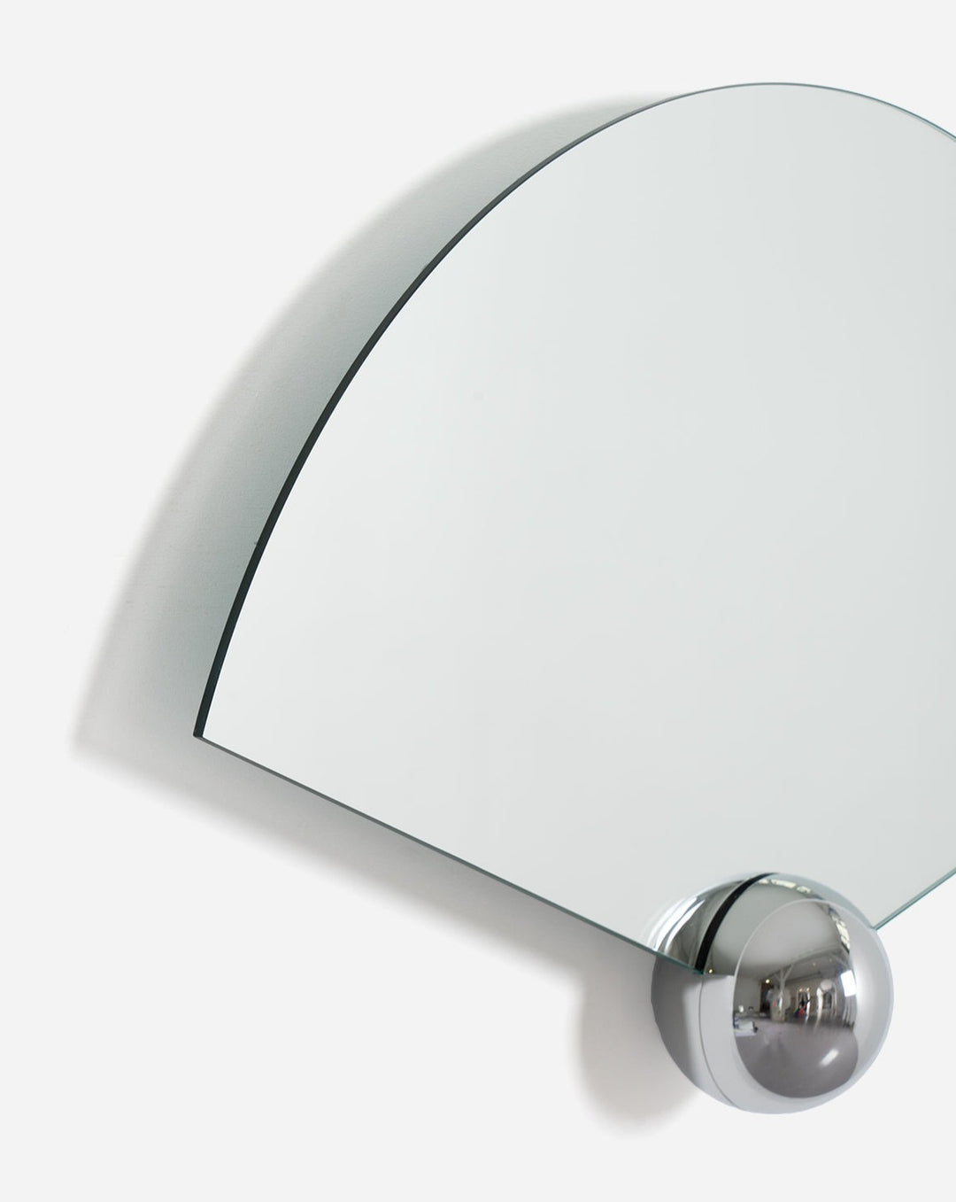 Fan-shaped wall mirror by Moustache Paris with a chrome sphere at the bottom corner.