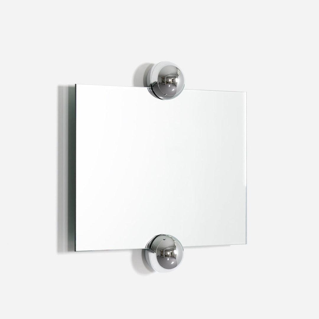 Rectangular wall mirror with chrome ball details by Moustache Paris against a plain white wall.
