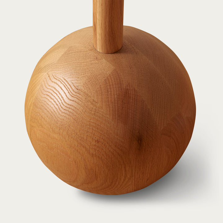 Wood floor lamp by McMullin with a bulbous base and cylindrical stand.