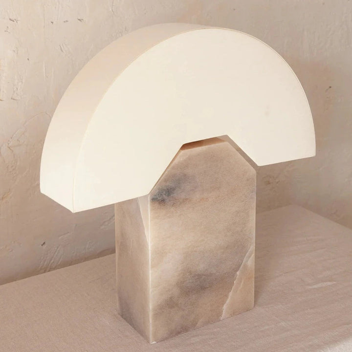 Tobacco table lamp by Shop Dessein Parke with a white lampshade and a marble base.