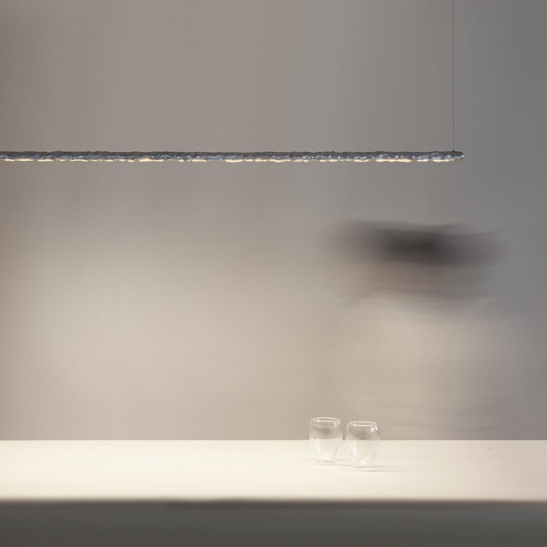 Aluminium linear ceiling light by Stem Design above a white bench