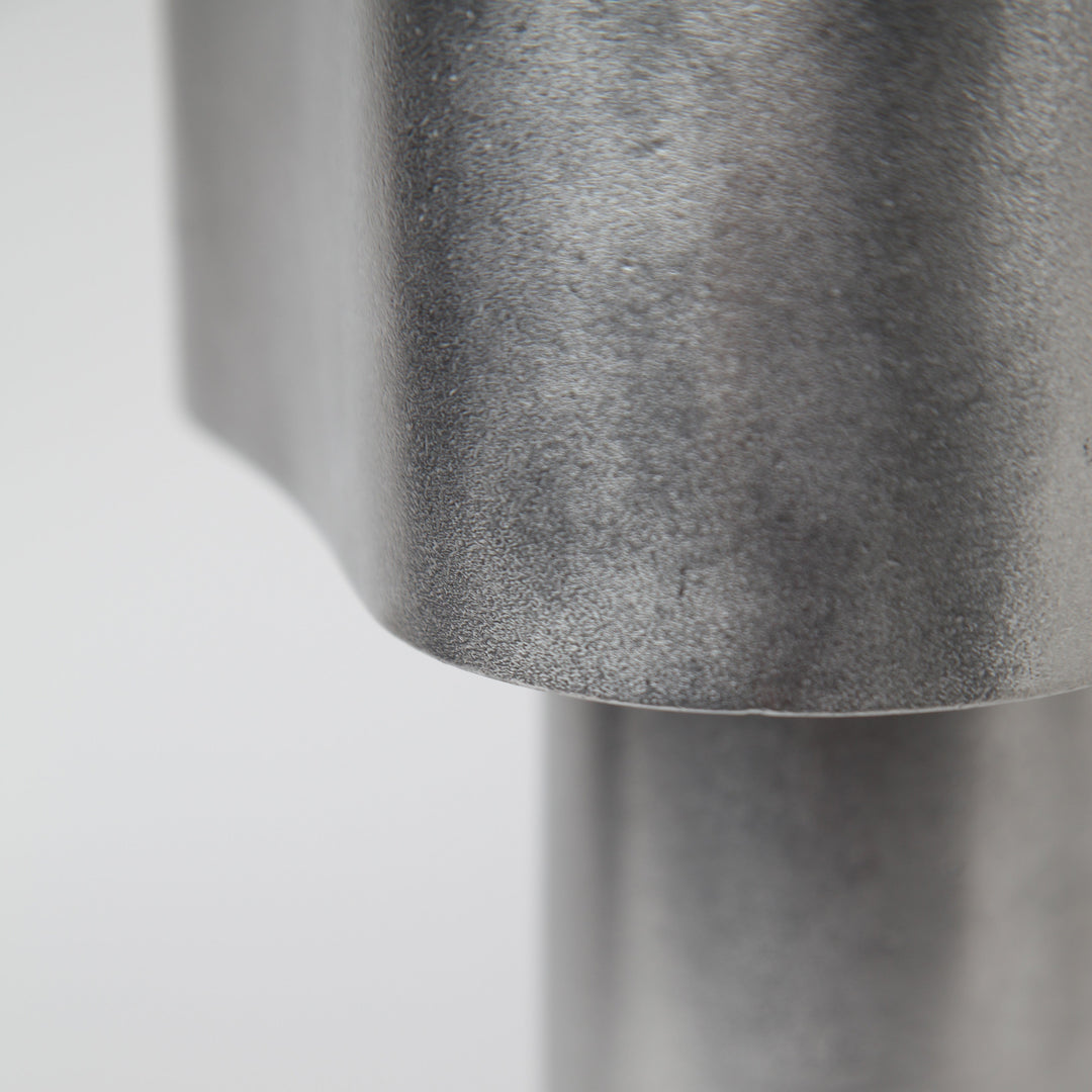 Close-up of Stem Design Coy light with a textured surface on a light grey background