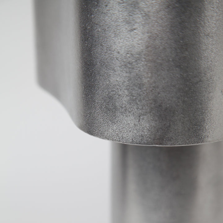 Close-up of Stem Design Coy light with a textured surface on a light grey background