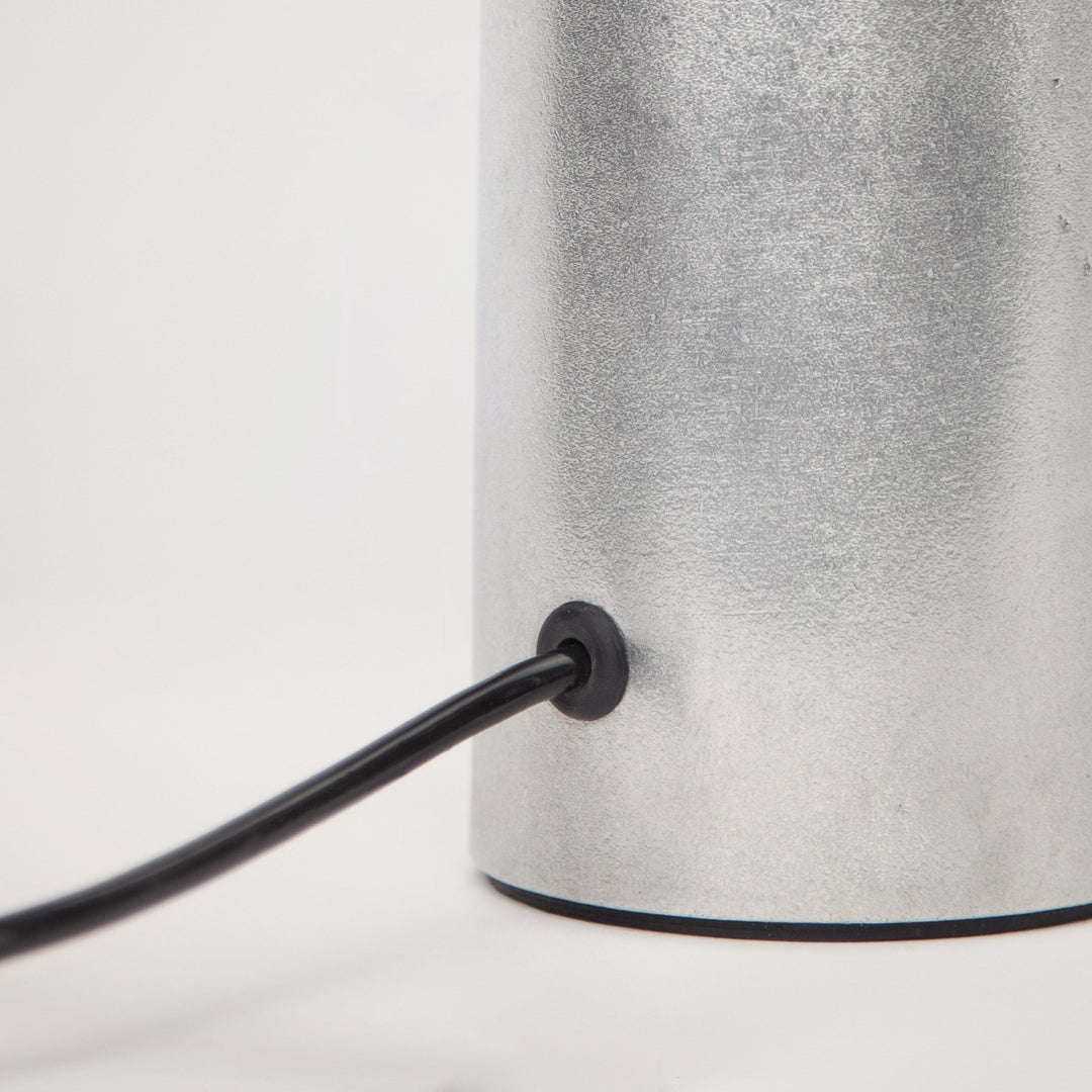 Detail shot of Stem Design Coy lamp  with a black cord on a white background