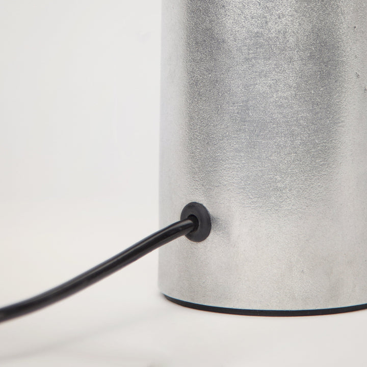 Detail shot of Stem Design Coy lamp  with a black cord on a white background