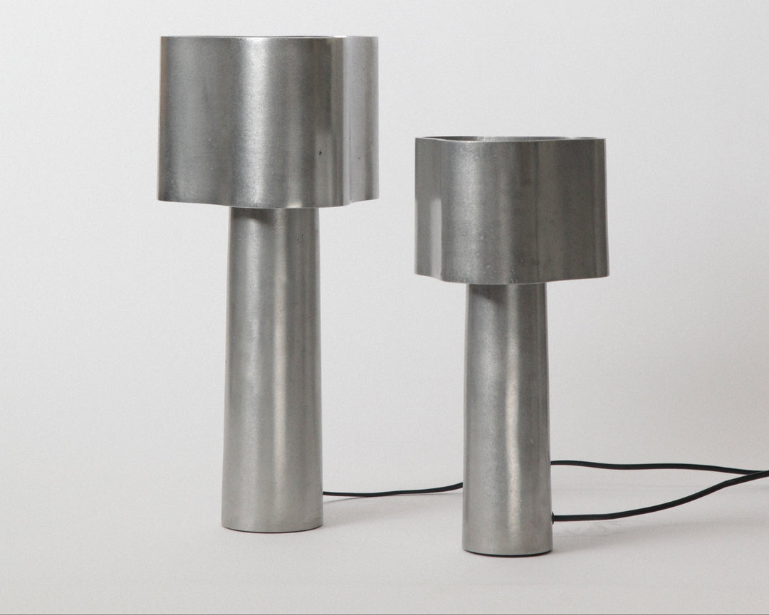 Two metallic table lamps on a white background