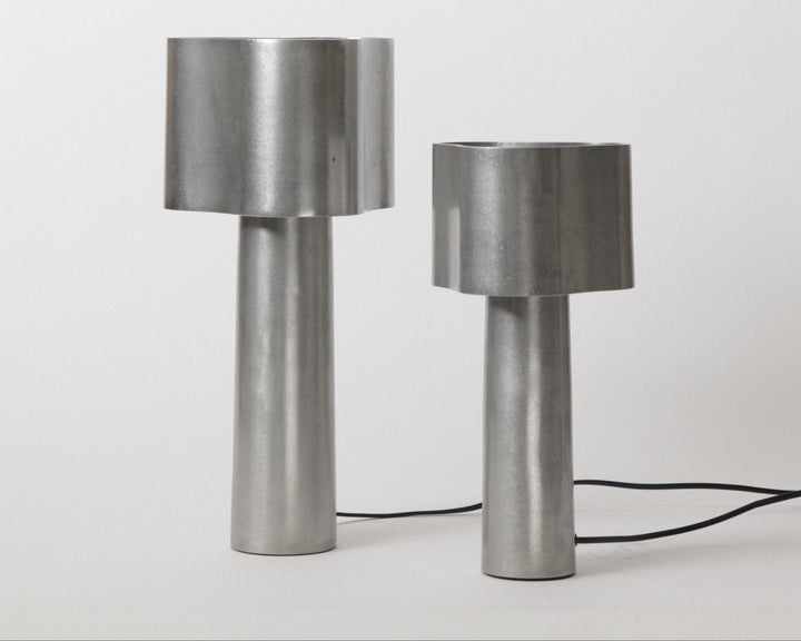 Two metallic table lamps on a white background