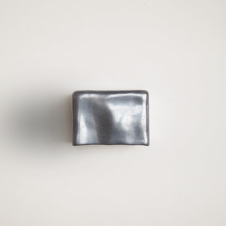 Metallic wall light by Stem Design on a light grey background