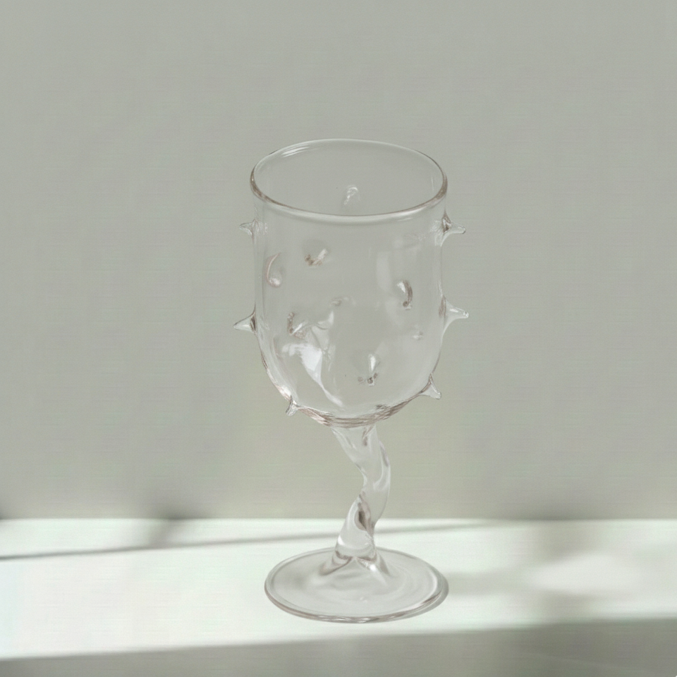 Handmade Clear glass with unique spike design on a light gray background