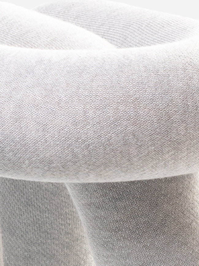 Light grey chair with a wool-blend upholstery and visible fabric texture.
