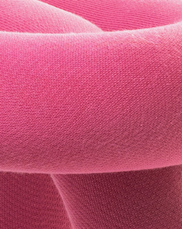 Pink bench with soft, textured fabric.