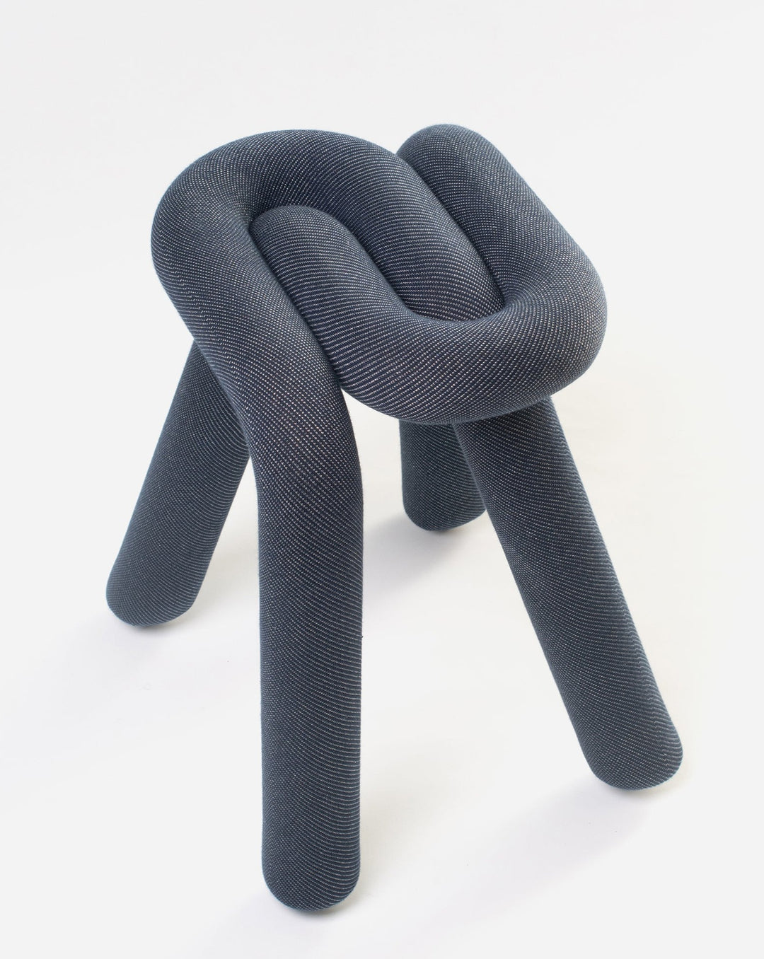 Purple stool by Moustache, featuring a unique knot design and soft, textured upholstery.