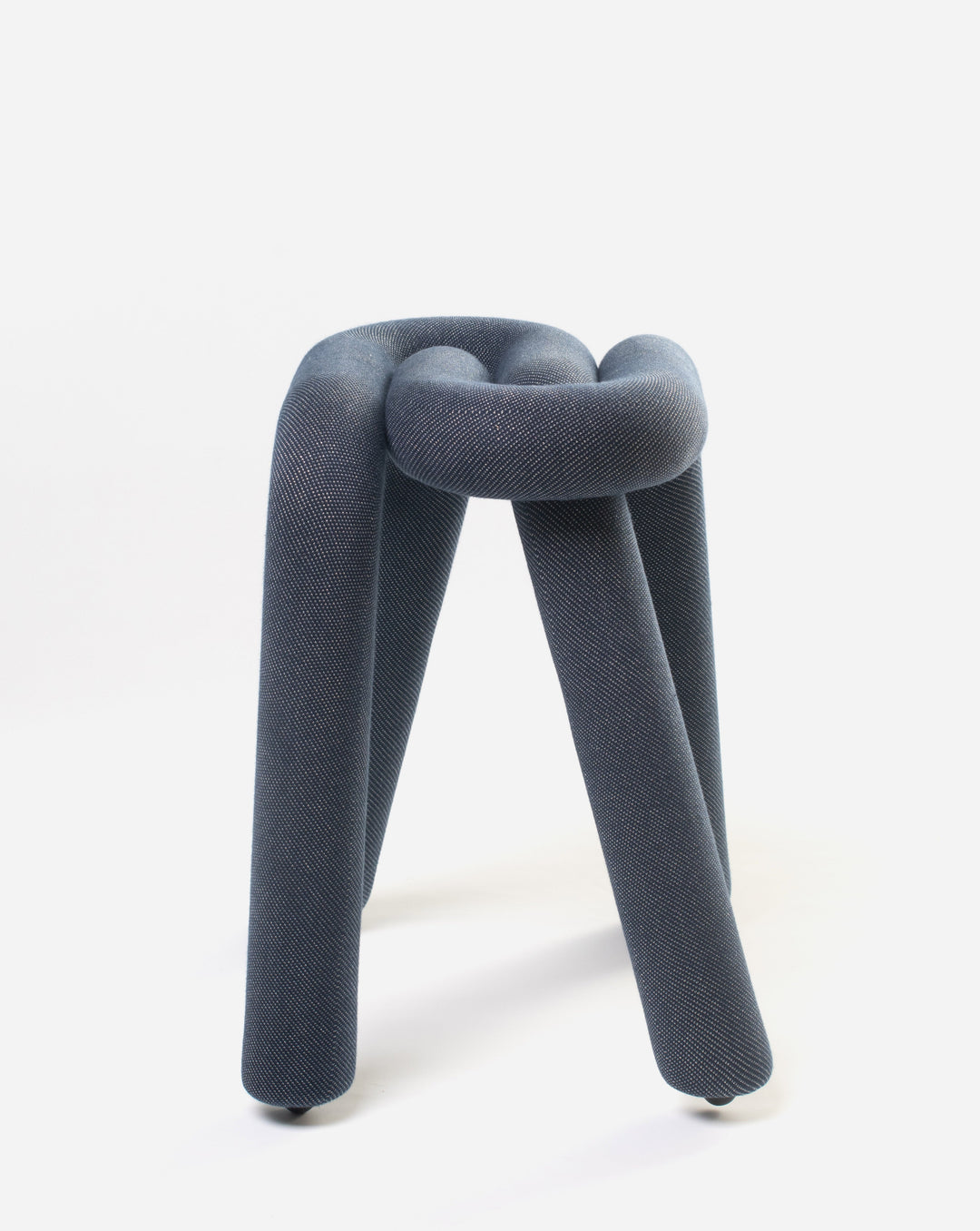 Purple upholstered stool by Moustache with a knot-like design and three rounded legs.