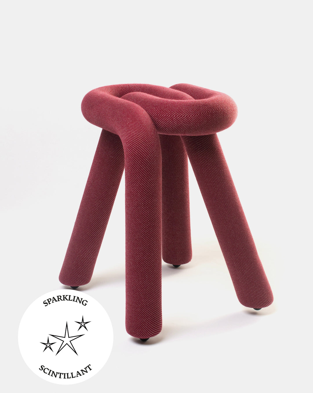 Purple fabric stool by Moustache with cylindrical legs and a looped, knot-like seat design.