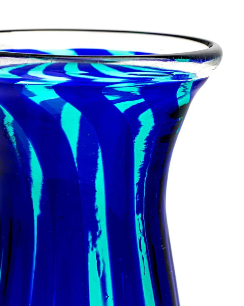 Blue and green glass vase by LAGUNA-B with swirled design and clear lip, cropped view.
