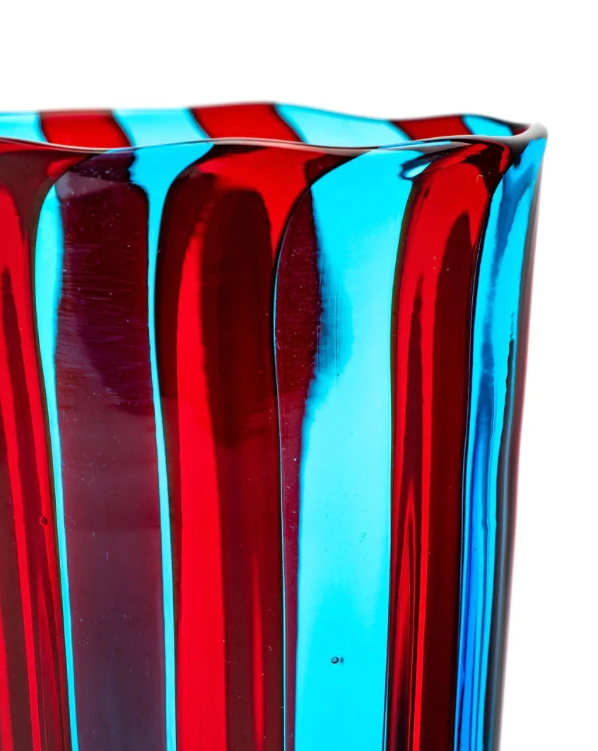 Striped drinking glass, blue and red by Laguna-B, with an uneven rim.