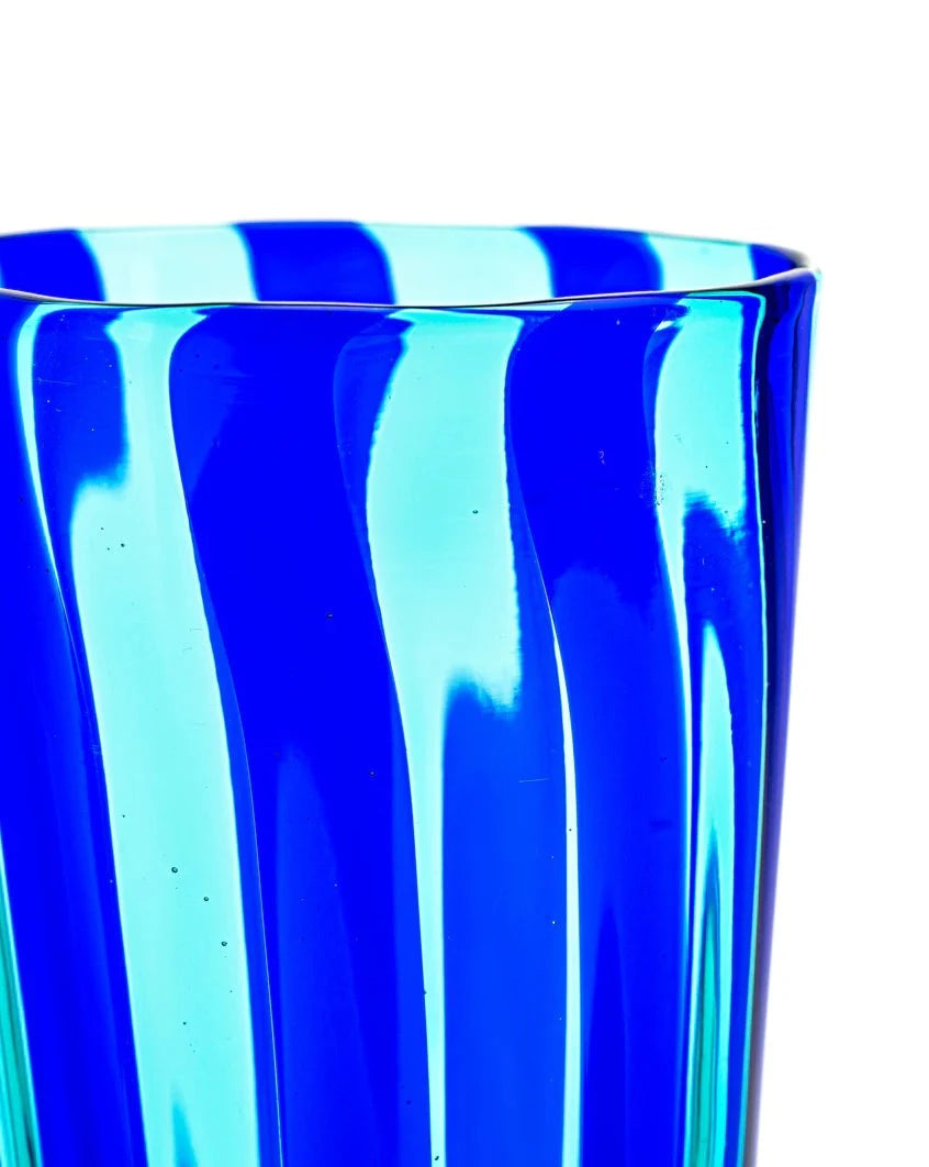 Blue and aqua glass tumbler by LAGUNA-B featuring a swirled pattern.