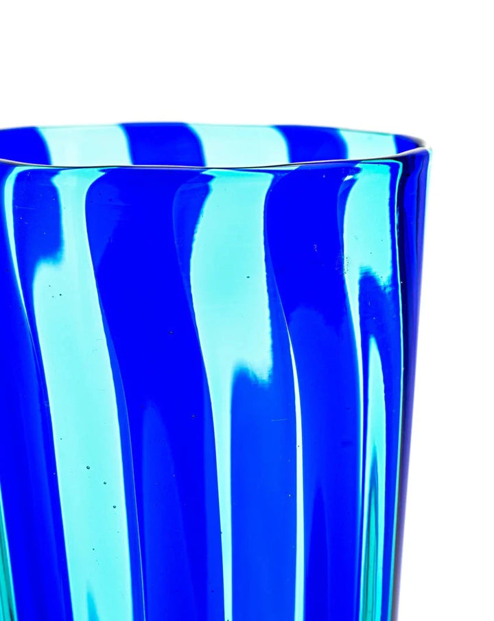 Blue and teal drinking glass by LAGUNA-B, featuring a striped, swirled design.