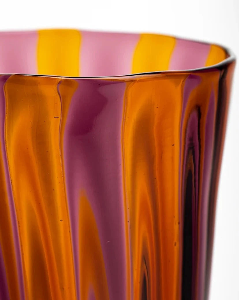 Striped glass tumbler by LAGUNA-B with vertical red and marine coloration.