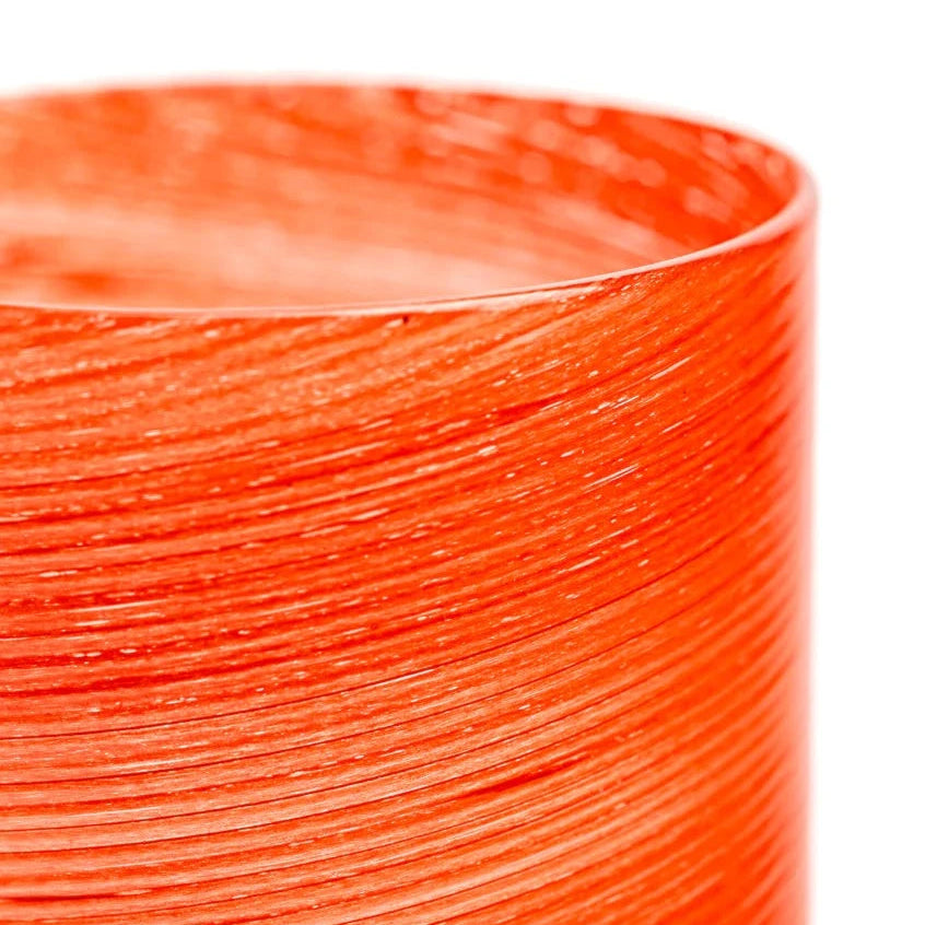 Coral "Dune" jar by LAGUNA-B featuring a textured, layered design and cylindrical shape.