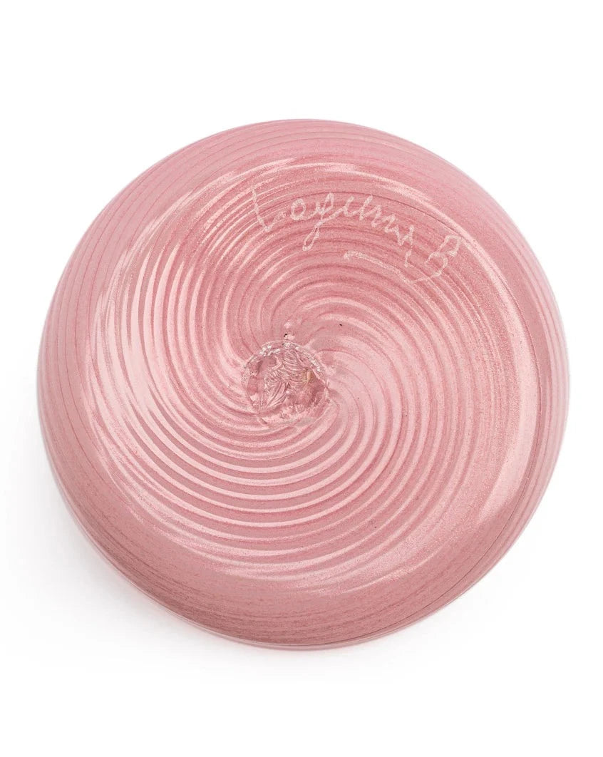 Pink glass tumbler by Laguna-B with a ridged spiral pattern emanating from the base.