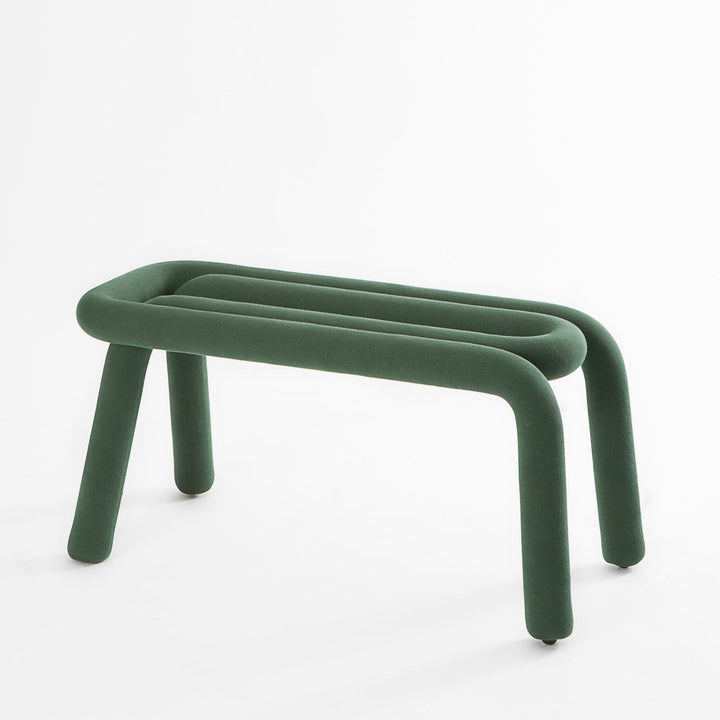 Forest green bench by Moustache Paris with soft, plush upholstery and unique, curved design.