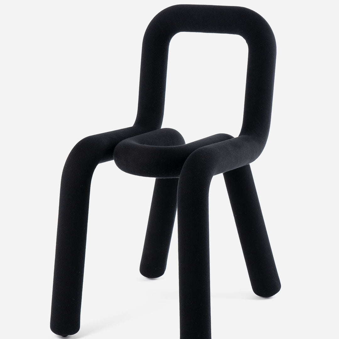 Black bold chair by Moustache Paris with velvet-like upholstery and rounded back.
