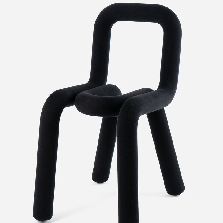 Black bold chair by Moustache Paris with velvet-like upholstery and rounded back.
