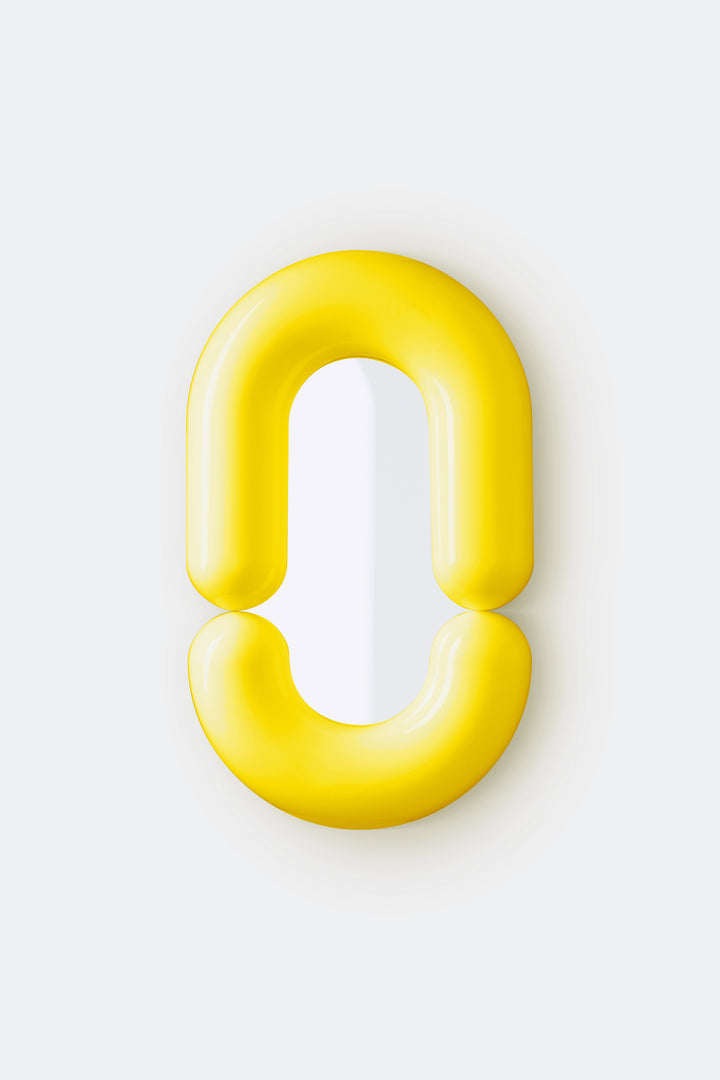 Yellow wall mirror by Moustache Paris with a smooth, glossy finish, and a rounded, minimalist design.