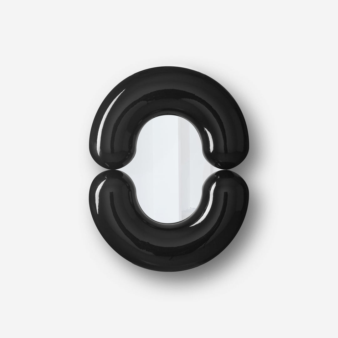Black wall mirror by Moustache Paris with rounded design and a glossy finish.
