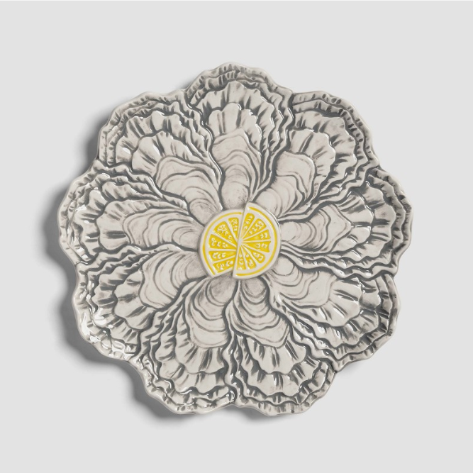 Gray oyster plate by &Klevering with a decorative lemon slice in the center.