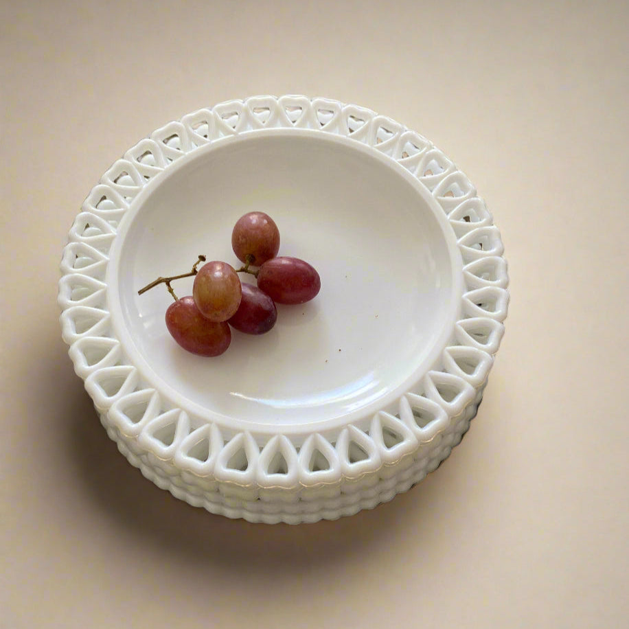 White glass plate with a heart border, vintage Swedish style, with red grapes inside.