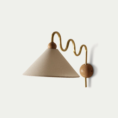 Beige fabric wall sconce by McMullin with a wavy brass arm and wooden mounting.
