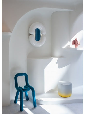 White Zodiac wall mirror by Moustache Paris, displayed on a white interior wall with rounded edges and a blue interior.