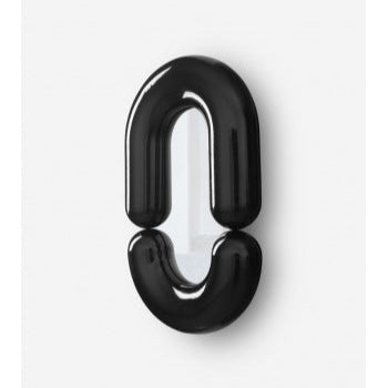 Black Zodiac medium wall mirror by Moustache Paris with a glossy, curved, link-shaped design.
