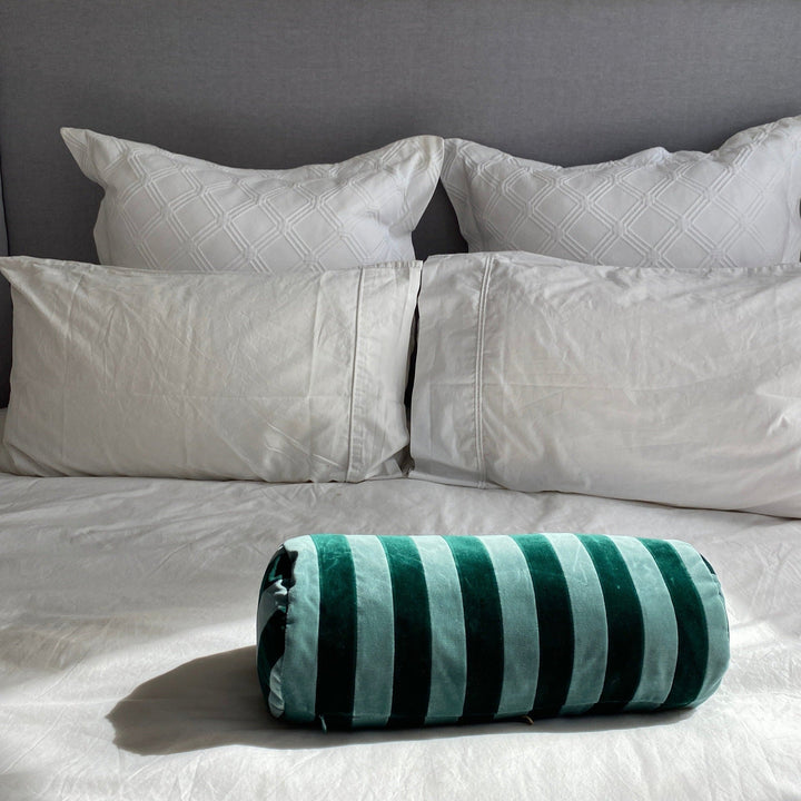 Handmade in Denmark, this Christina Lundsteen bolster cushion will lend a dash of rich colour to your living space.  Fabric: 100% cotton velvet removable cover  Inner: Removable cushion filled with duck feather and down  Size: 14 cm diameter x 45 cm long