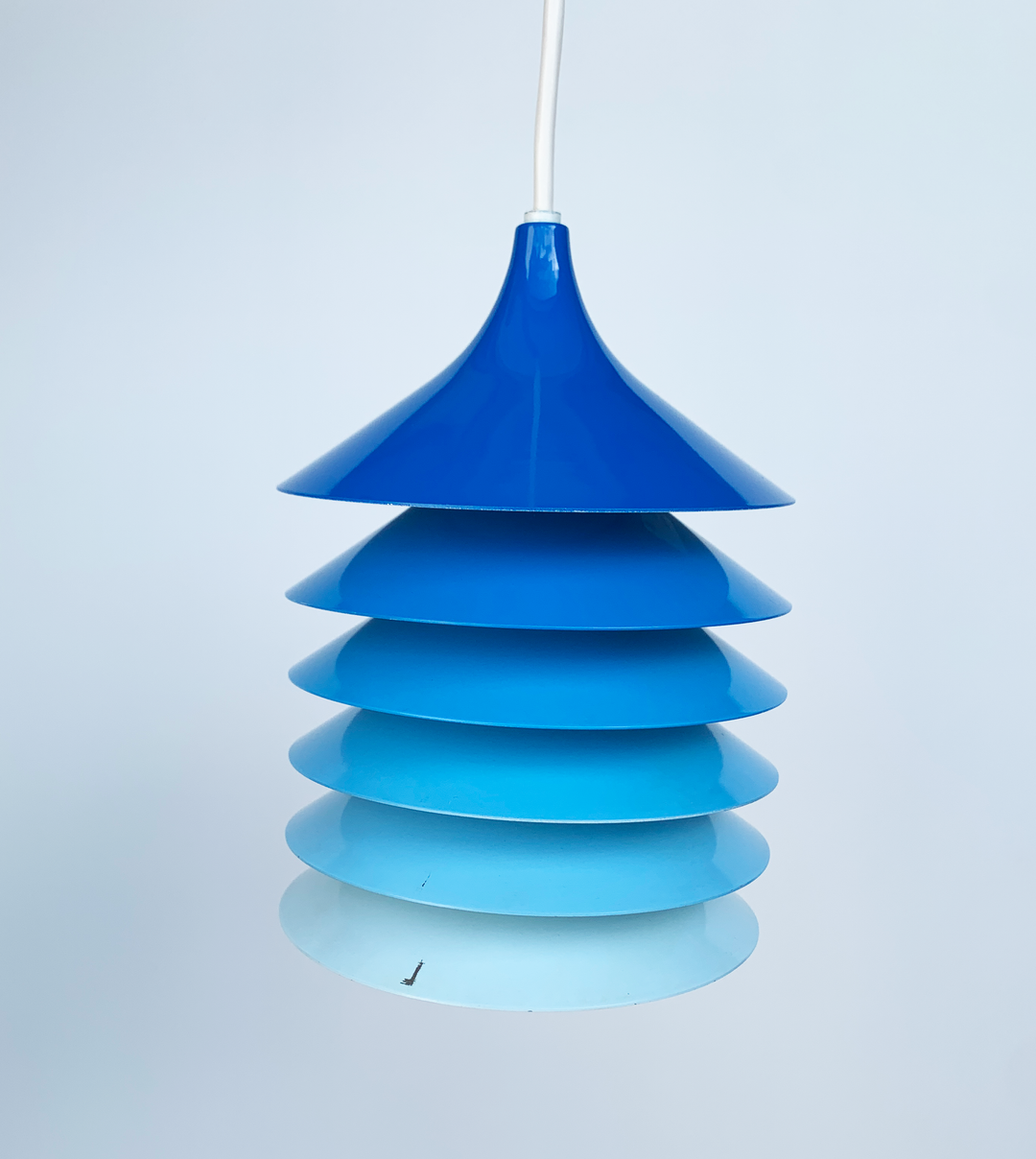 Blue pendant light by IKEA from the 1980s, featuring a tiered, conical shade with graduating shades.